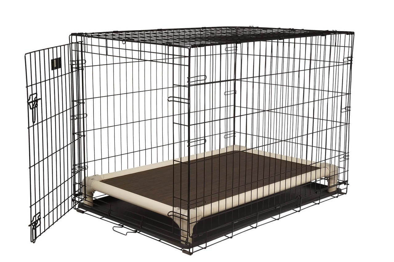 A cozy dog bed and open metal crate sit side by side indoors.